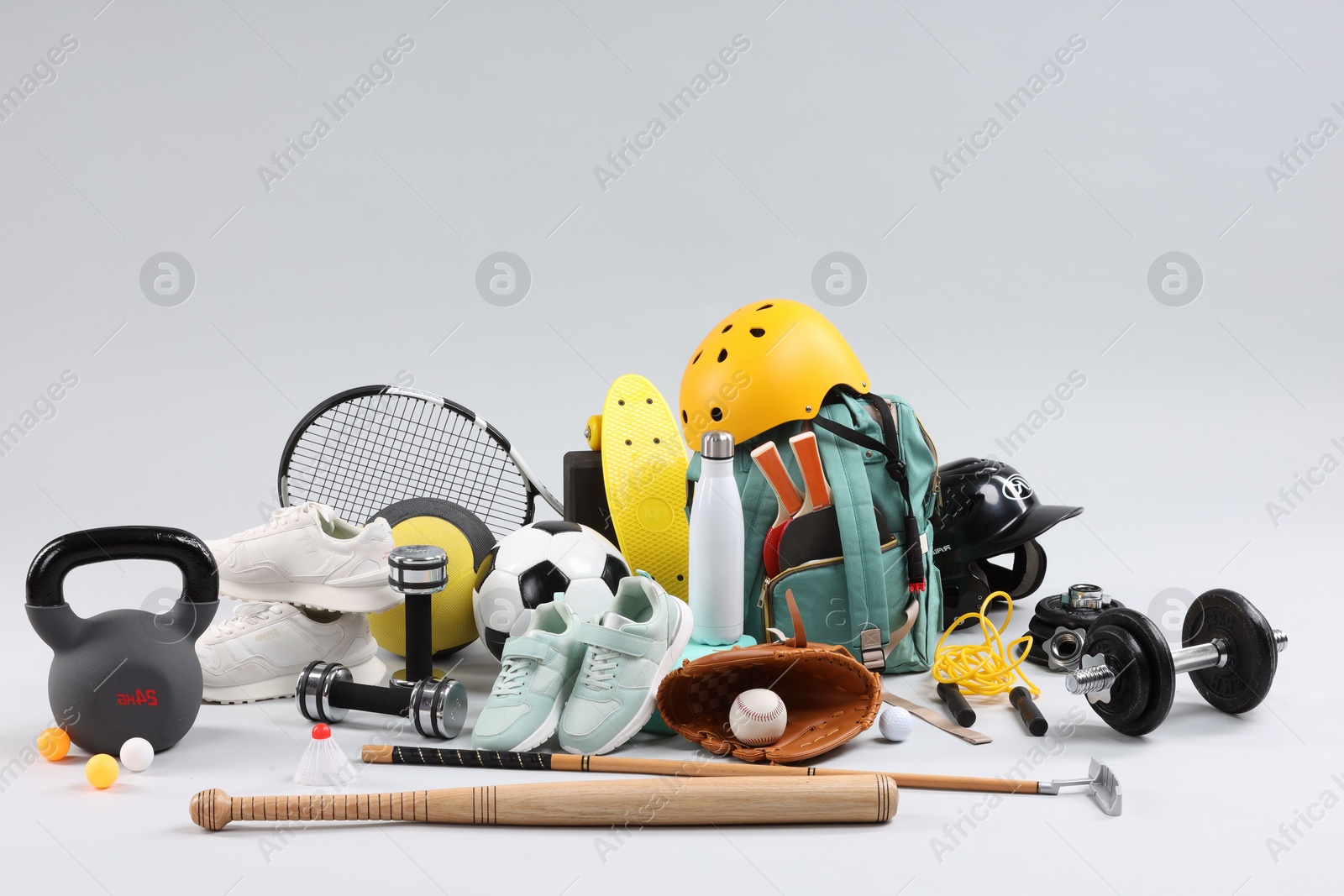 Photo of Many different sports equipment on light grey background