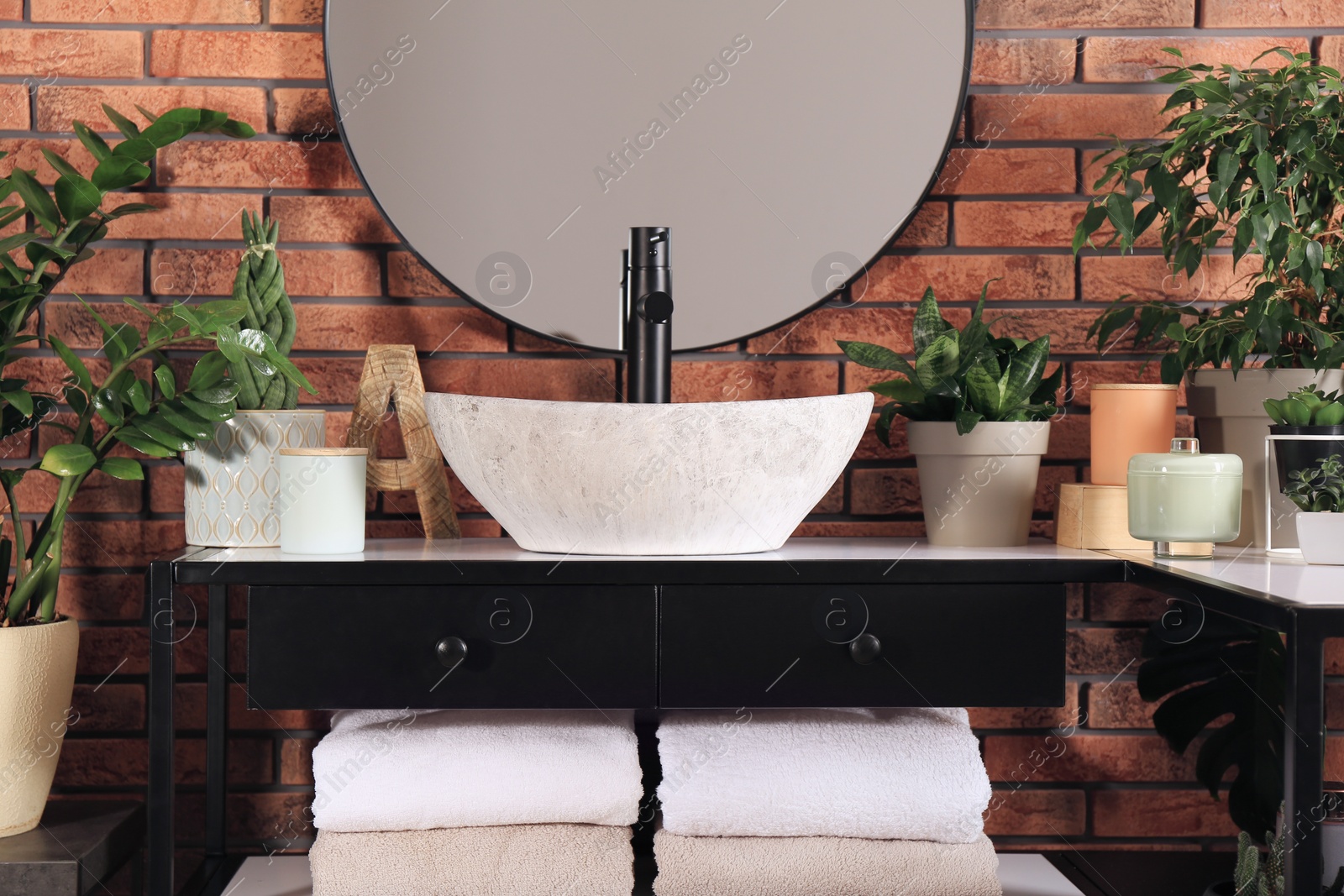 Photo of Stylish sink and beautiful green houseplants in bathroom. Interior design