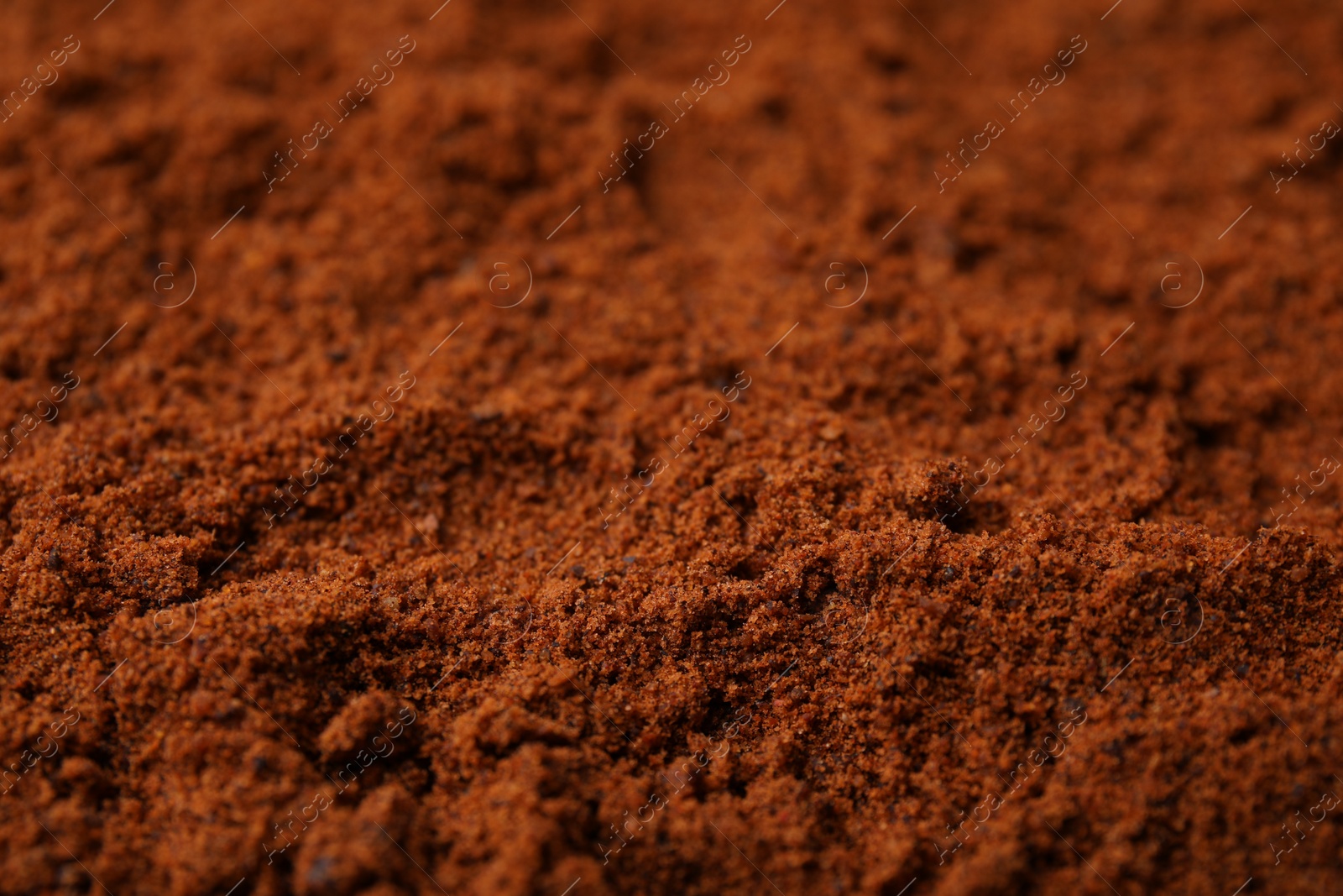 Photo of Heap of nutmeg powder as background, closeup