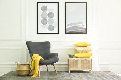 Stylish living room with armchair. Interior design in grey and yellow colors