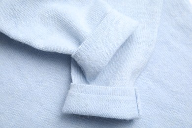 Warm cashmere sweater as background, top view
