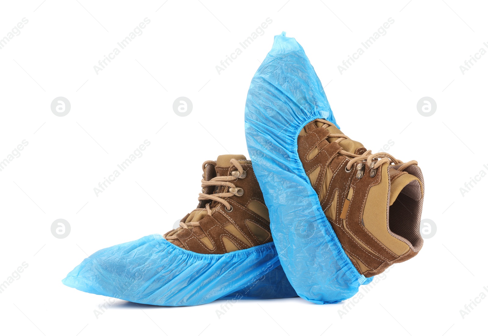 Photo of Boots in blue shoe covers isolated on white
