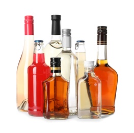 Photo of Bottles with different alcoholic drinks on white background