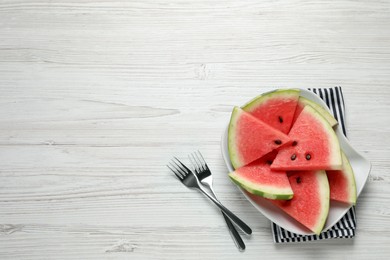 Photo of Delicious fresh watermelon slices on white wooden table, flat lay. Space for text