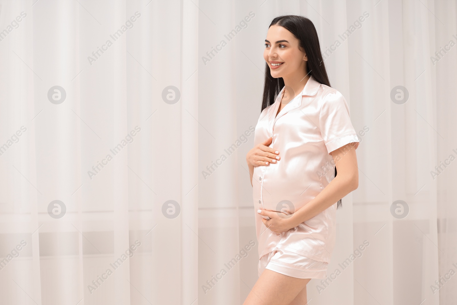 Photo of Happy pregnant woman indoors, space for text