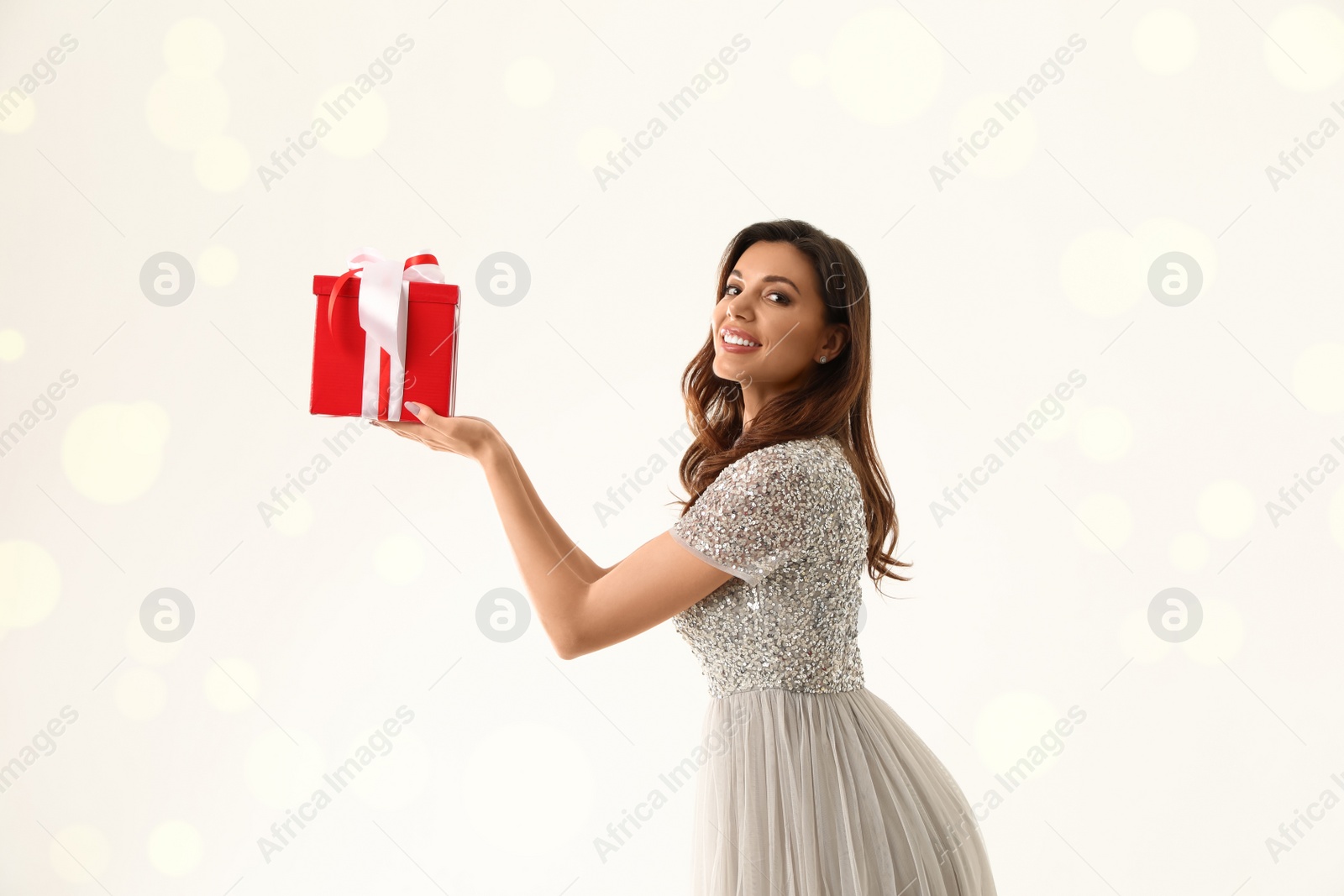 Photo of Beautiful woman with Christmas gift on white background