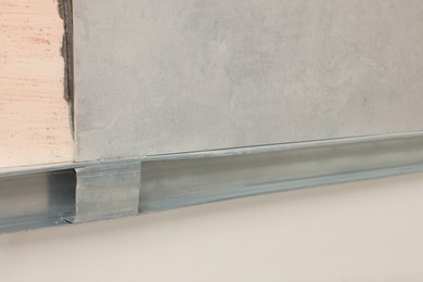 Photo of Adhesive mix with tile and metal stud on wall, closeup