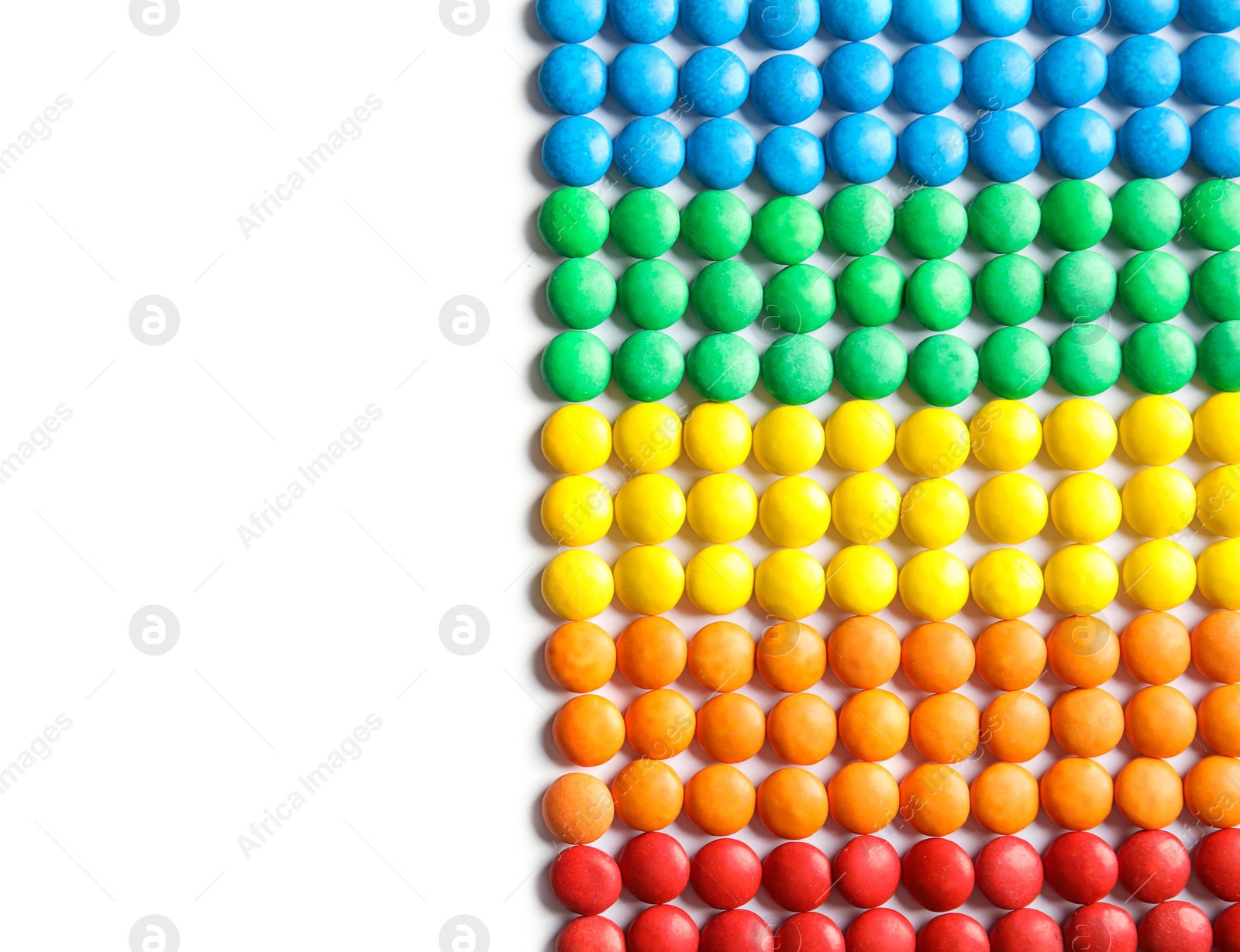 Photo of Tasty colorful candies on white background, top view