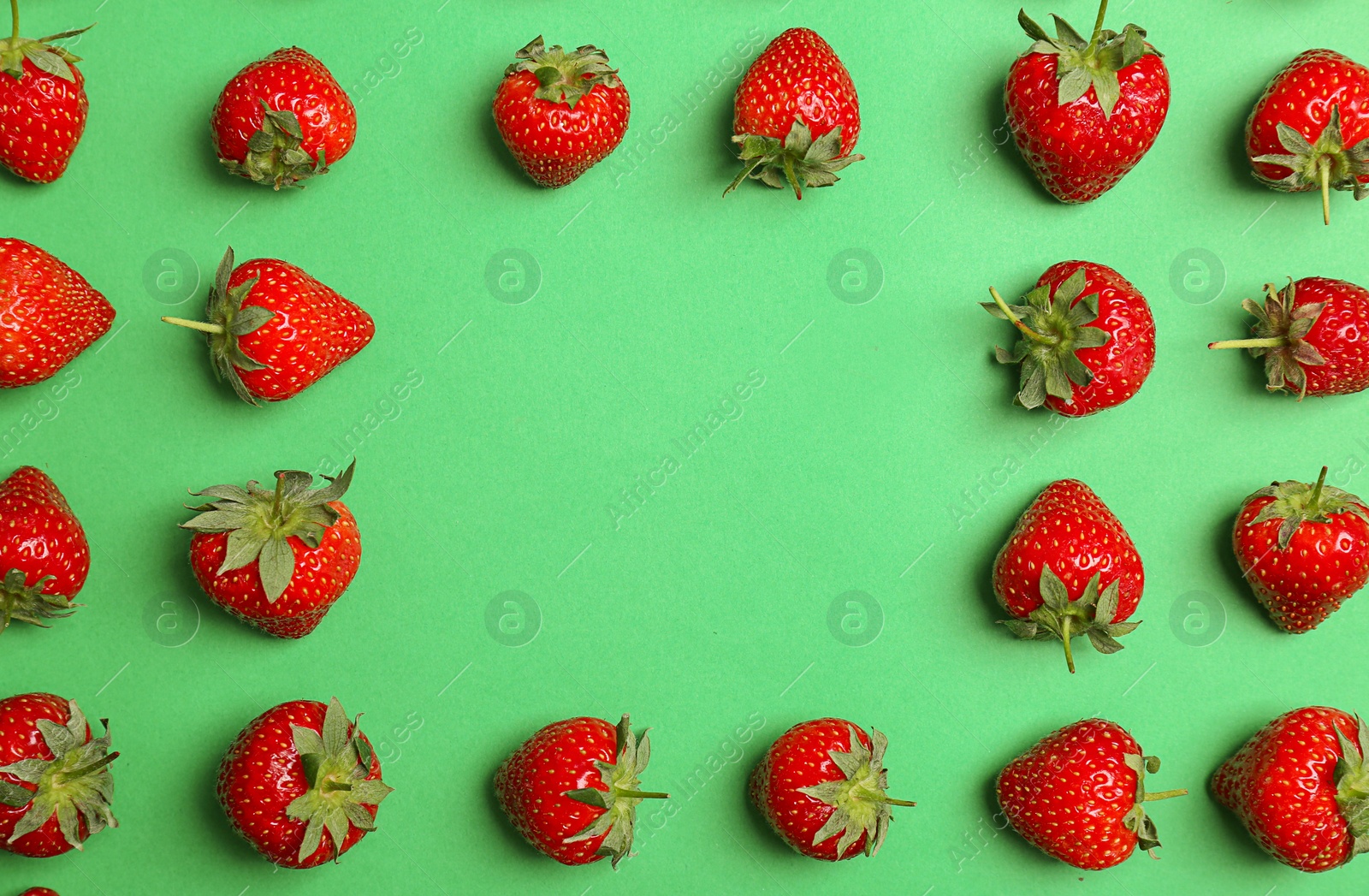 Photo of Flat lay composition with with tasty ripe strawberries on color background