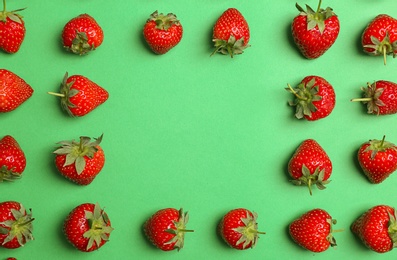 Photo of Flat lay composition with with tasty ripe strawberries on color background