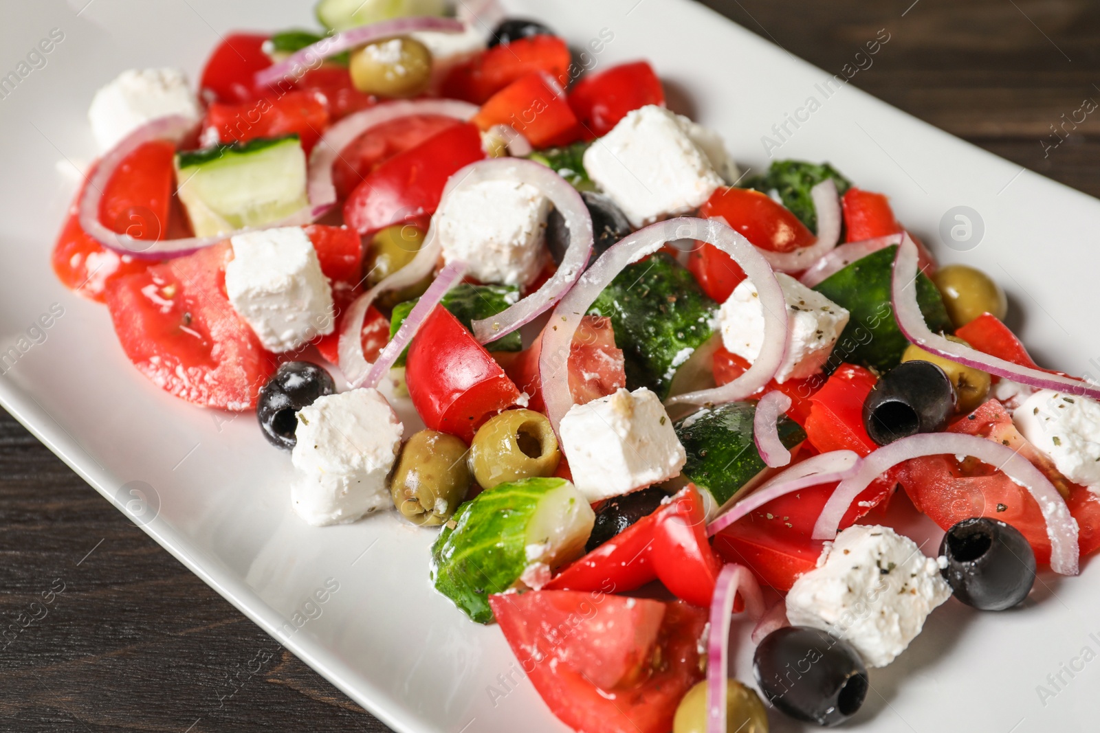 Photo of Plate with delicious salad on table, closeup