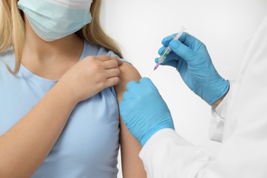 Doctor giving hepatitis vaccine to patient on white background, closeup