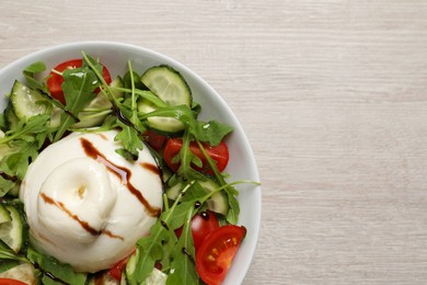Photo of Delicious burrata salad on white wooden table, top view. Space for text
