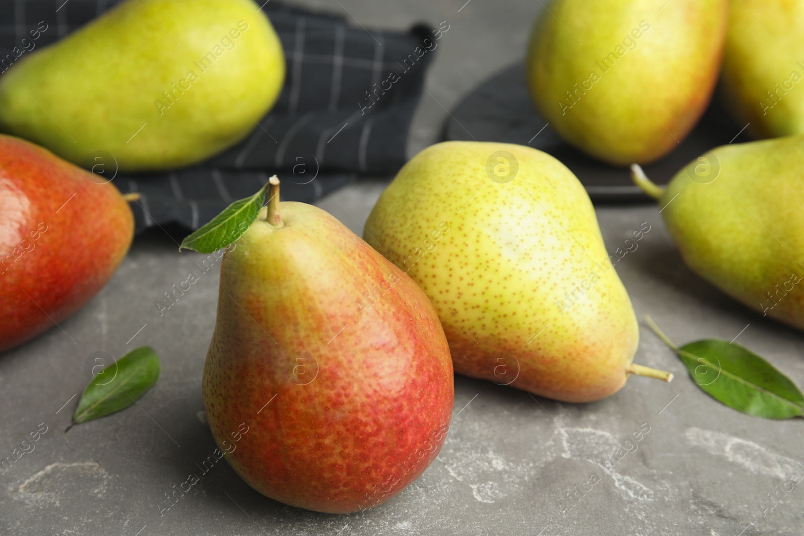 Photo of Ripe juicy pears on grey stone background