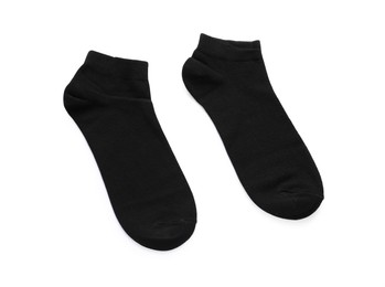 Photo of Pair of black socks on white background, top view