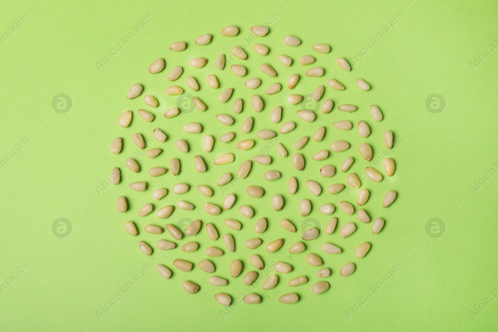 Photo of Flat lay composition with pine nuts on color background