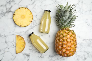 Delicious pineapple juice and fresh fruit on white marble table, flat lay