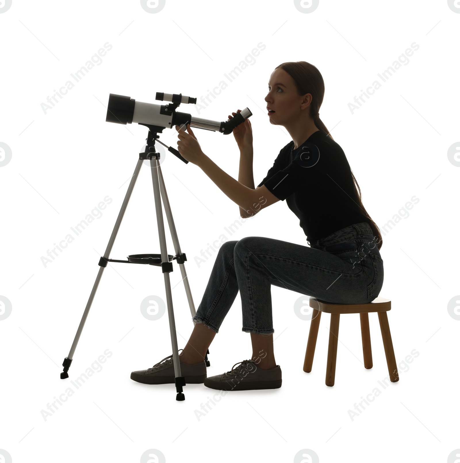 Photo of Young astronomer looking at stars through telescope on white background