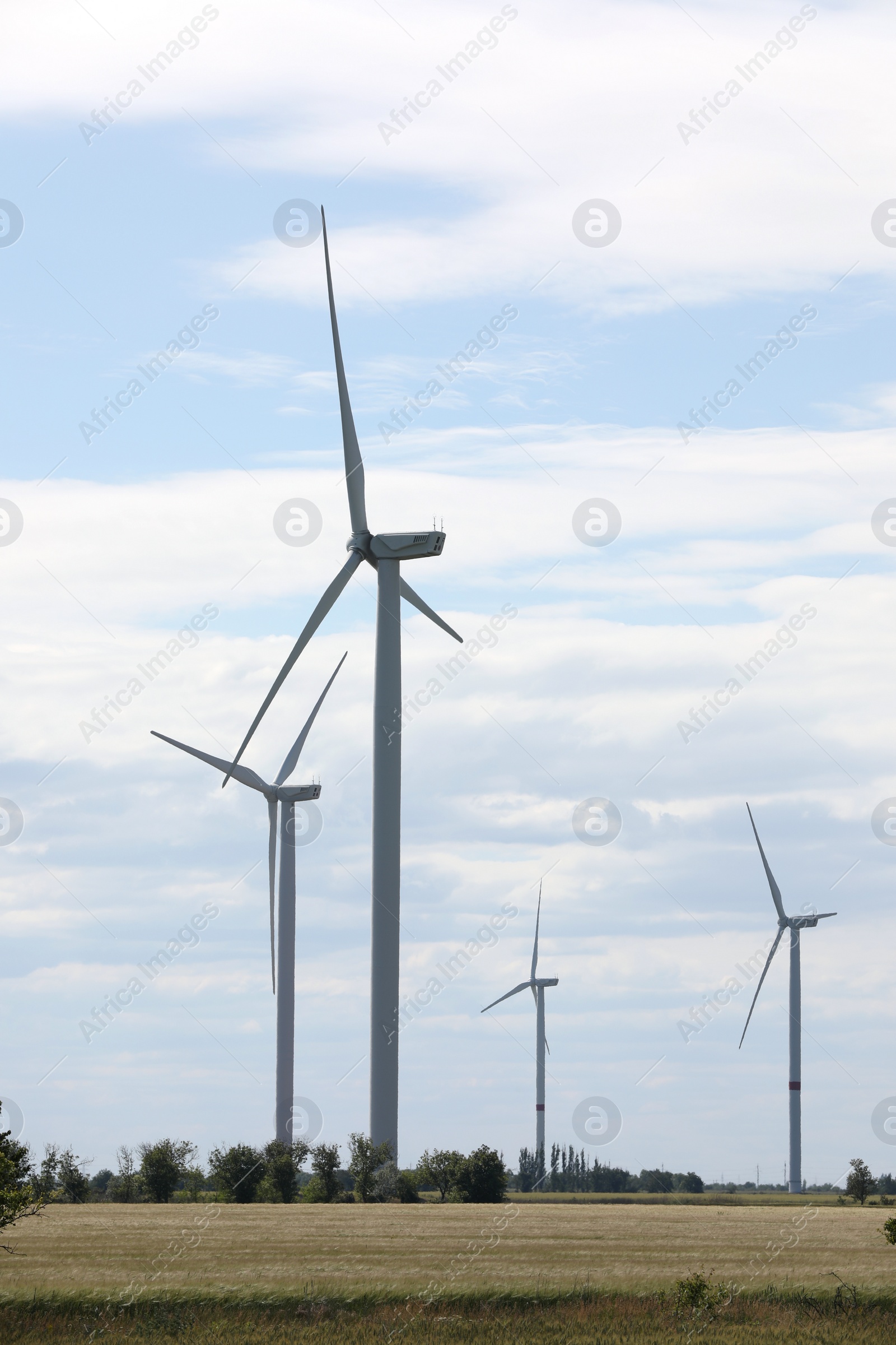 Photo of Beautiful view of field with wind turbines. Alternative energy source