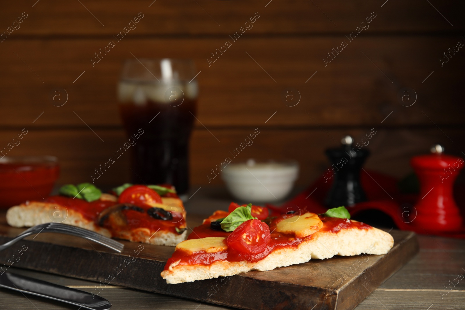 Photo of Slices of delicious pita pizza on wooden table