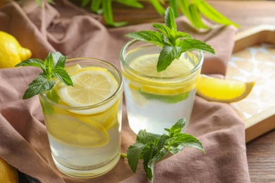 Photo of Natural lemonade with mint in glasses on tray