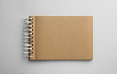 Photo of Notebook with brown paper pages on white background, top view