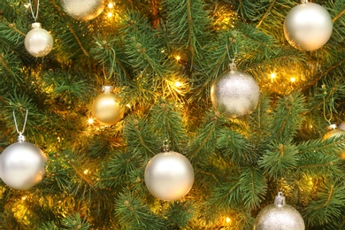 Photo of Glowing bright fairy lights and beautiful baubles on Christmas tree