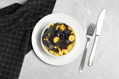 Photo of Delicious fresh carrot salad served on grey marble table, flat lay