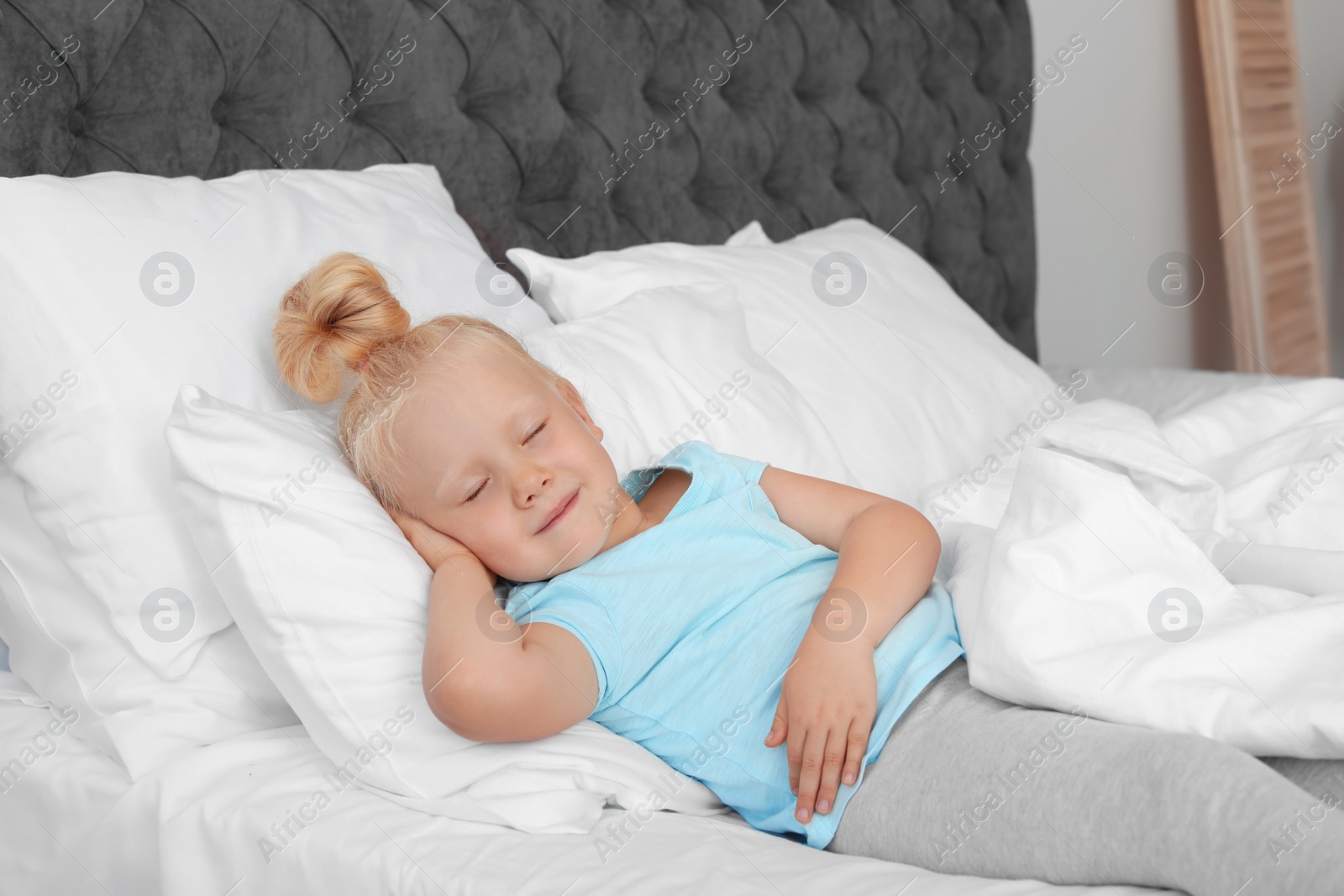 Photo of Cute little girl sleeping in bed. Nap time