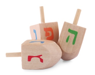 Photo of Wooden Hanukkah traditional dreidels on white background