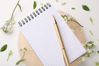 Photo of Guest list. Notebook, pen and beautiful spring tree blossoms on white background, flat lay