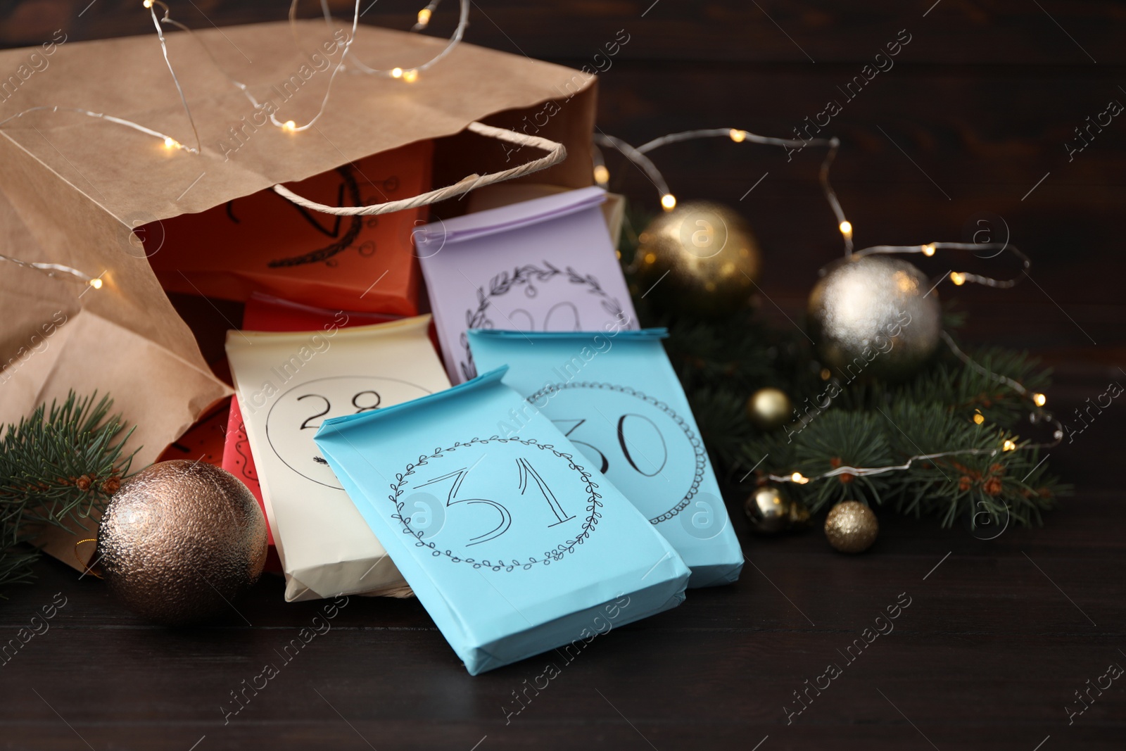 Photo of Set of gifts and Christmas decor on wooden table. New Year advent calendar