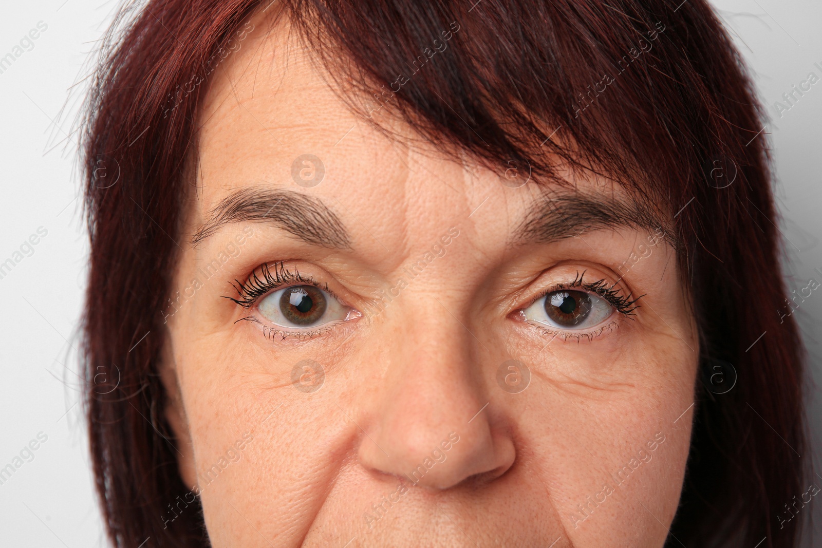 Photo of Skin care. Senior woman on white background, closeup