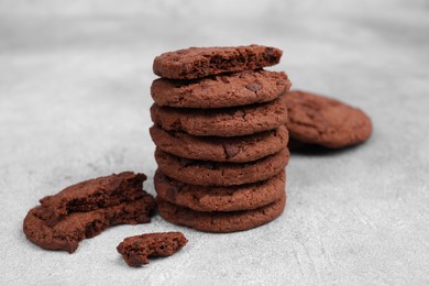 Tasty chocolate cookies on light grey table, closeup