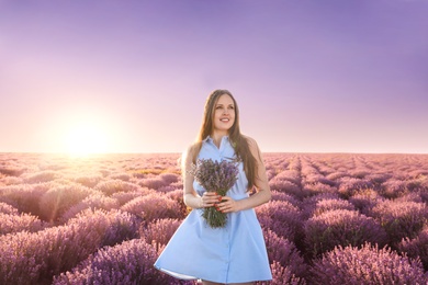 Photo of Young woman with bouquet in lavender field