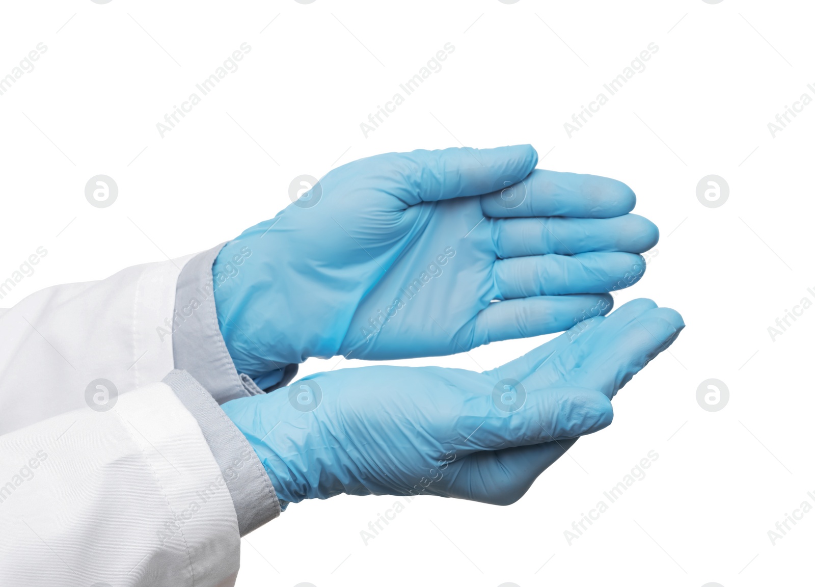 Photo of Doctor wearing light blue medical gloves holding something on white background, closeup