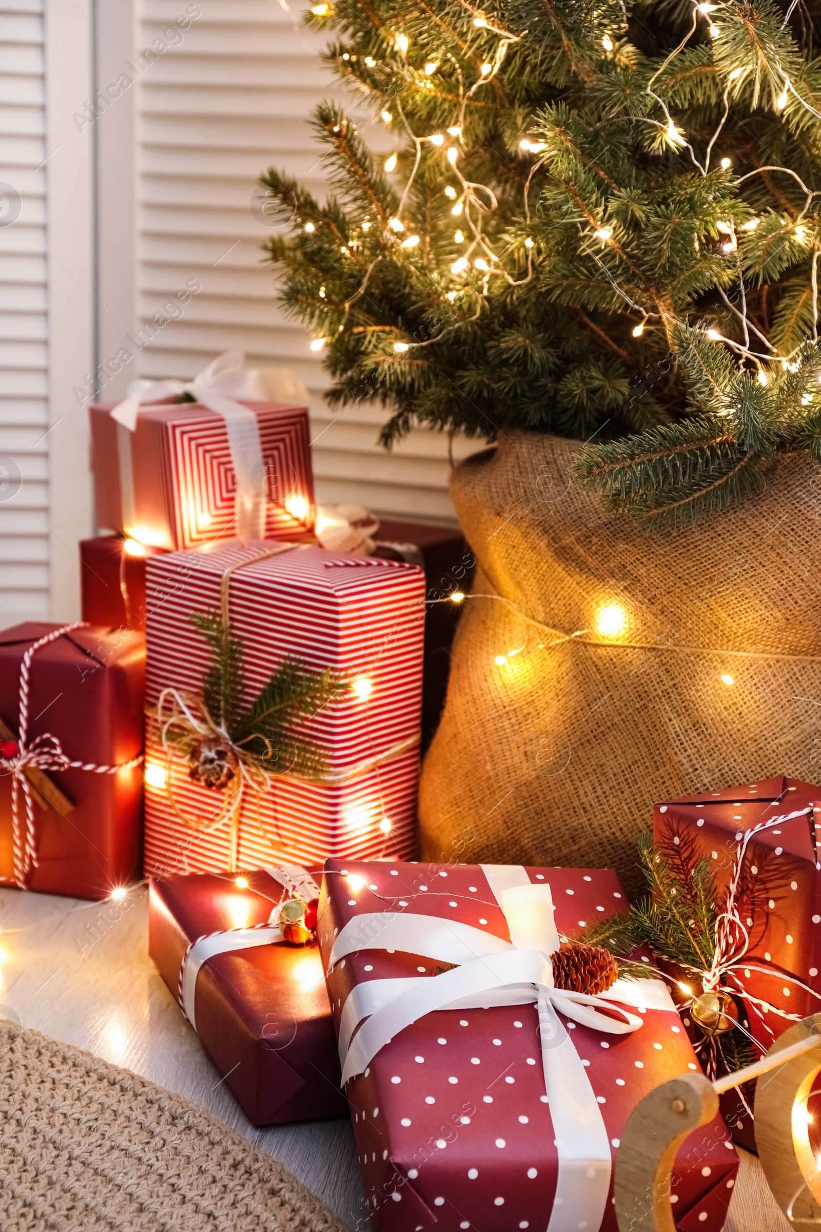 Photo of Many different gifts under Christmas tree indoors