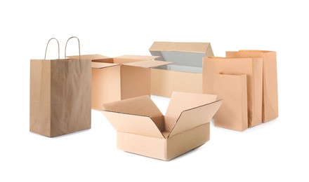 Image of Set with different paper bags and cardboard boxes on white background