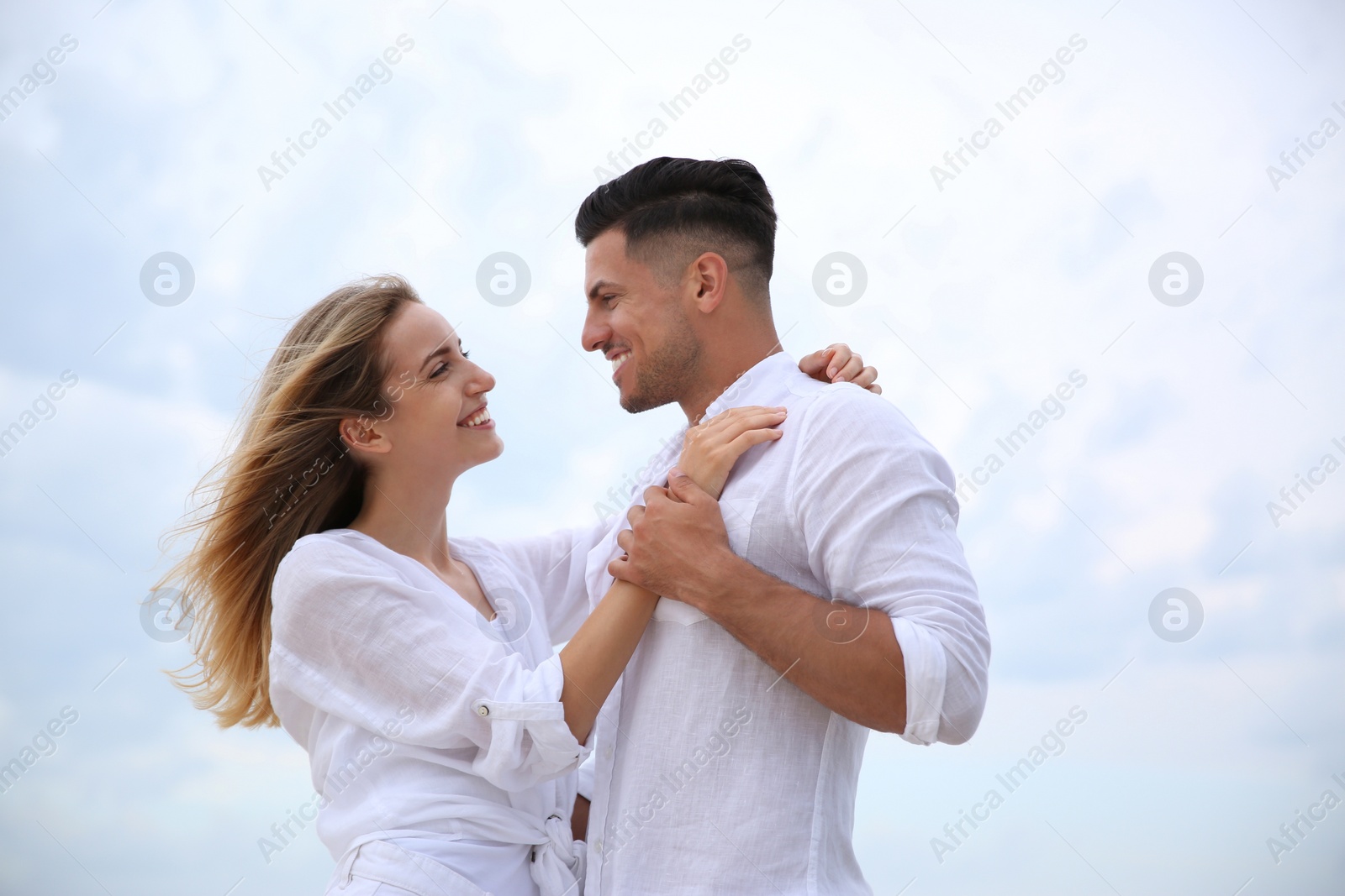 Photo of Happy couple on sea beach. Romantic walk