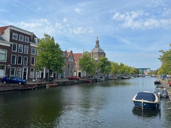 Leiden, Netherlands - August 28, 2022; Beautiful view of buildings near canal and boat on sunny day