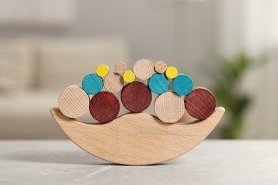 Photo of Wooden balance toy on table indoors, closeup. Children's development