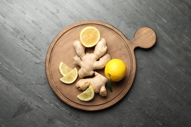 Fresh lemons and ginger on grey table, top view