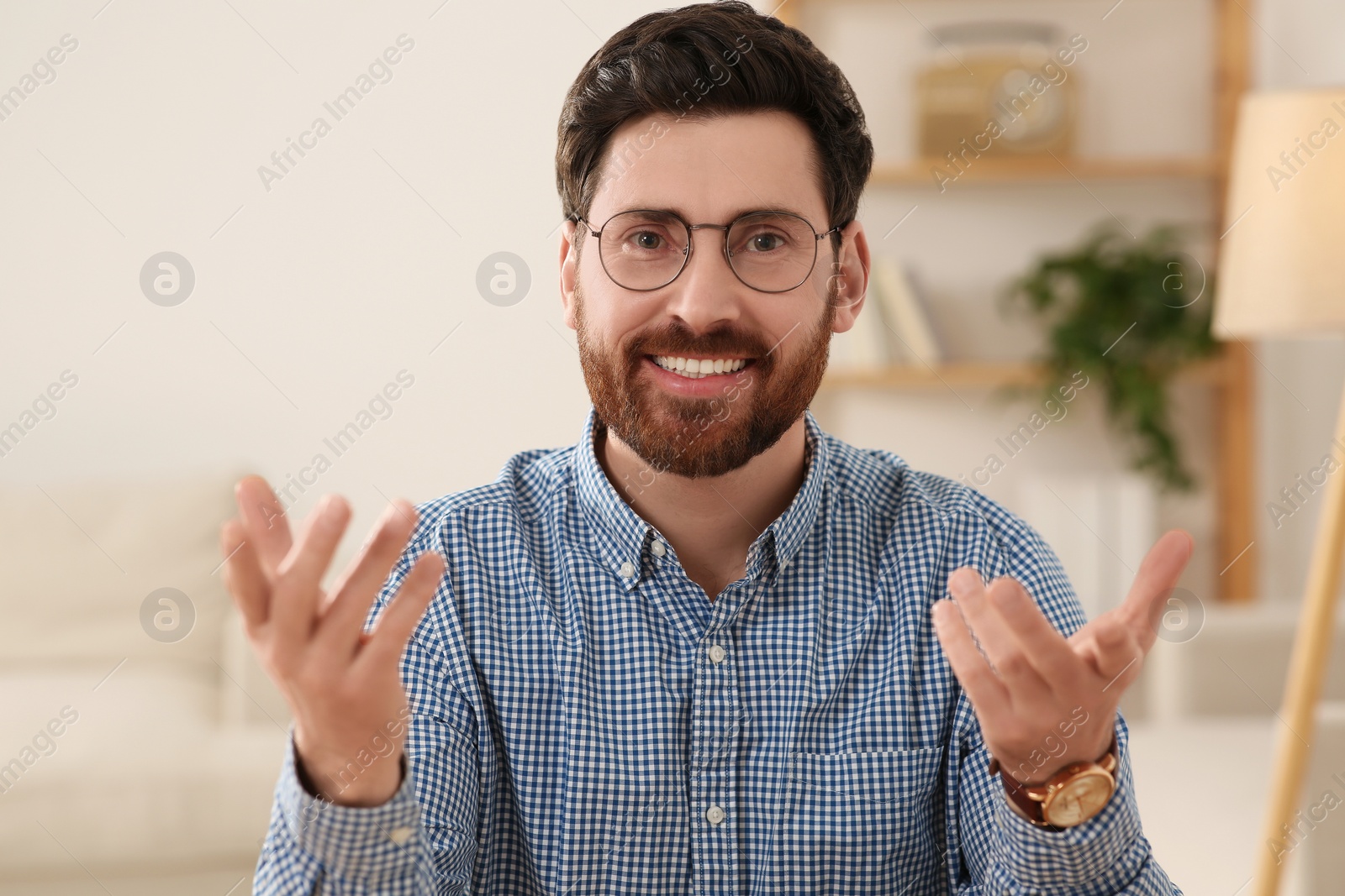 Photo of Happy man having video call at home, view from web camera