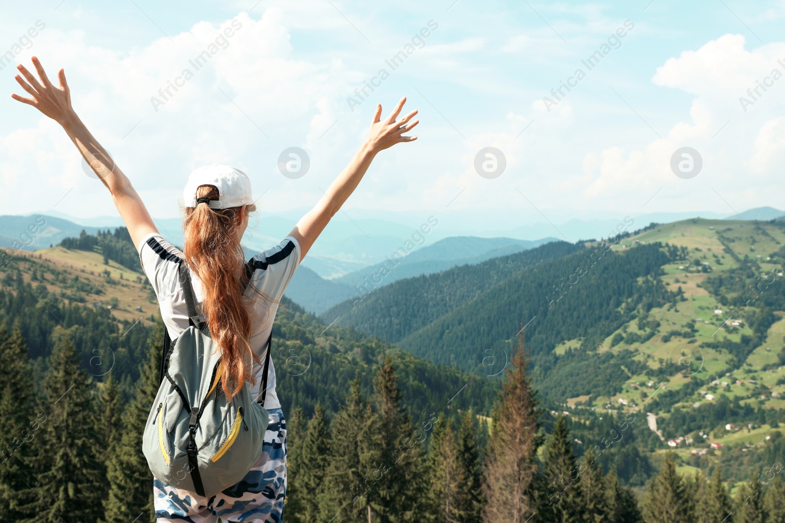 Photo of Woman with backpack in wilderness. Mountain landscape