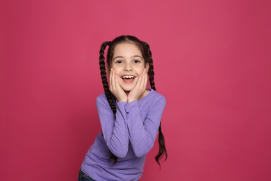 Photo of Portrait of little girl laughing on color background