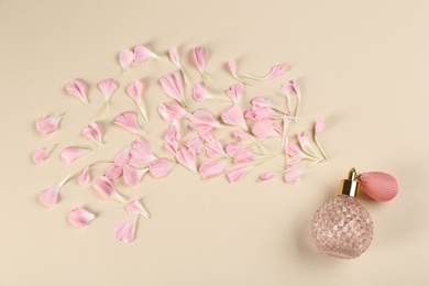Flat lay composition with bottle of perfume on beige background