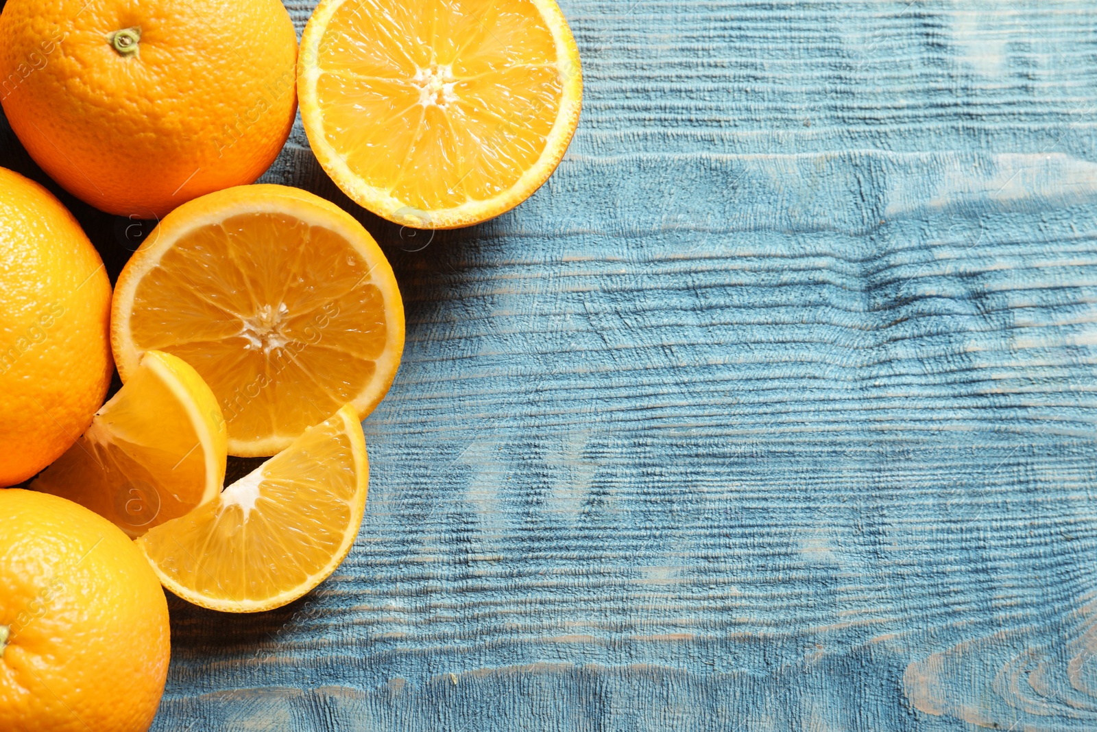 Photo of Flat lay composition with ripe oranges and space for text on wooden background