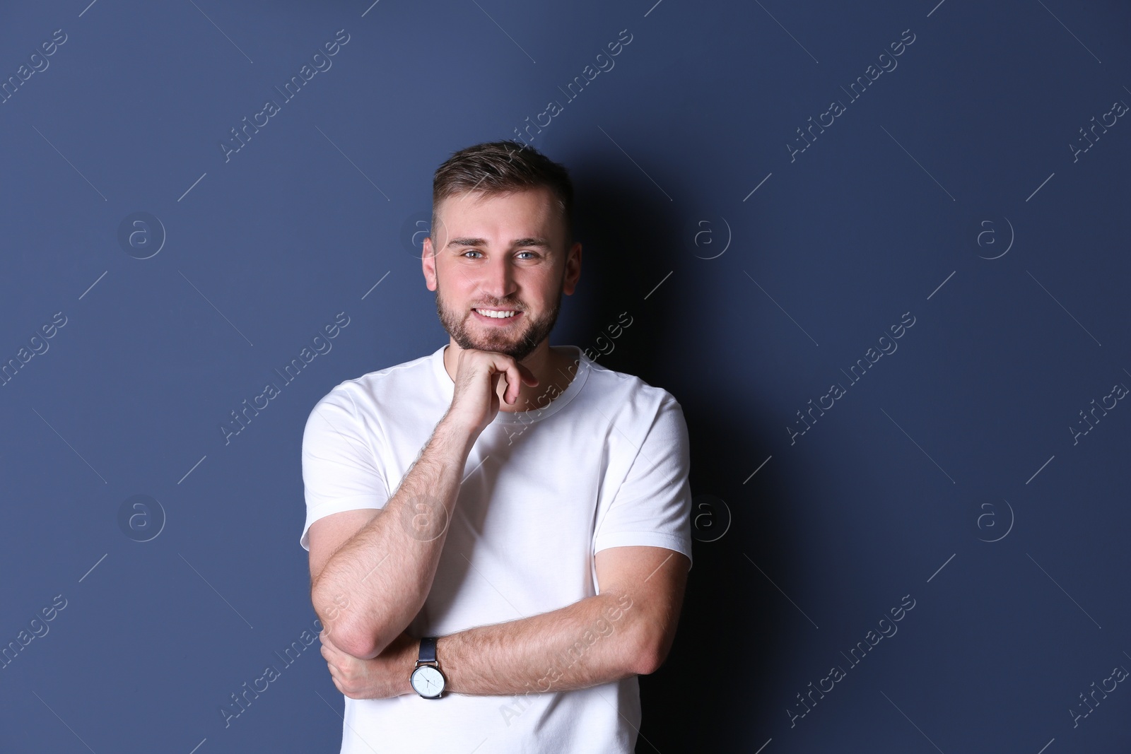 Photo of Portrait of handsome happy man on grey background