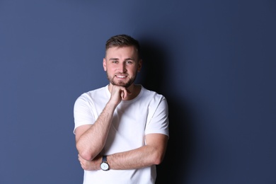 Portrait of handsome happy man on grey background