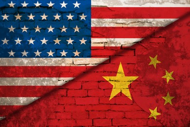 Image of Flags of USA and China on brick wall. International diplomatic relationships